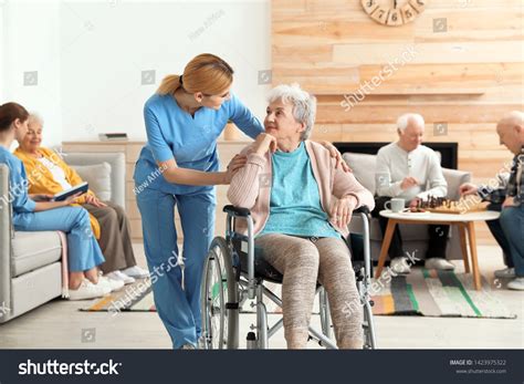 Nurses Assisting Elderly People Retirement Home Stock Photo 1423975322