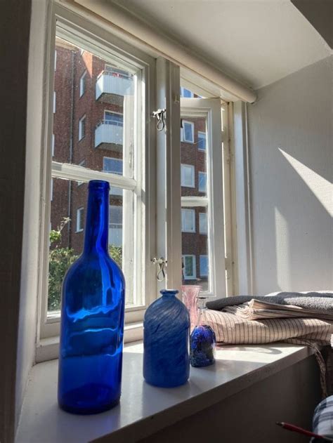 Two Blue Vases Sitting On A Window Sill