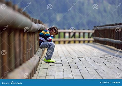 Sad boy sitting alone stock image. Image of plant, parade - 60113431