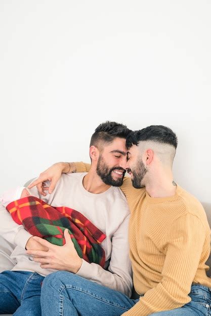 Free Photo Portrait Of Smiling Loving Gay Couple With Their Baby In Hand Isolated Against