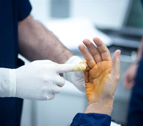 Premium Photo Midsection Of Doctor Applying Medicine On Hand