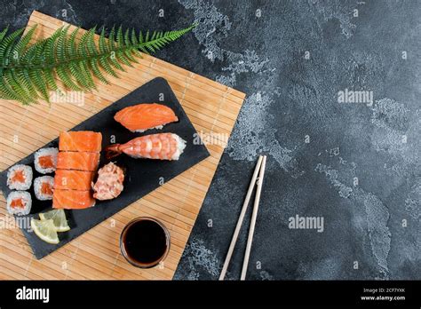 Sashimi Rolls On A Black Stone Slatter Close Up Of Sushi Set With