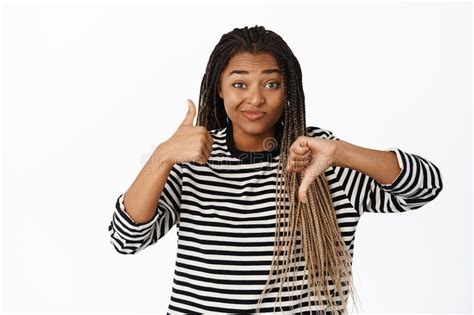 Portrait Of Smiling Black Girl Making Choice Pointing Sideways And