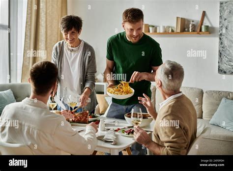 A Gay Couple Shares A Meal With Parents At Home Stock Photo Alamy
