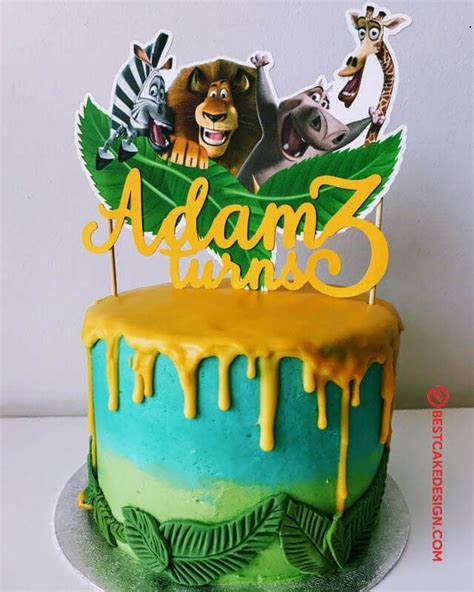 A Birthday Cake Decorated With Animals And Leaves