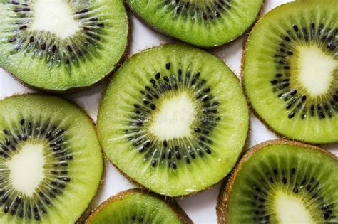 Kiwi Fruit Cut Into Pieces Against A Light Background Close Up With