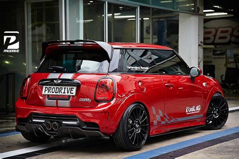 Red Mini Cabrio parked in front of a building