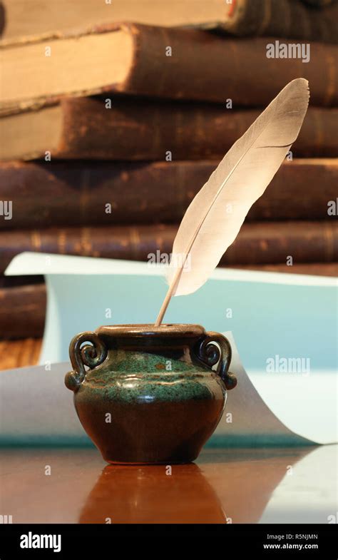 Still Life With Old Inkpot With Feather On Vintage Background With