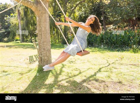 Pretty Brunette Swinging In Park Stock Photo Alamy