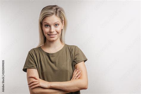 Studio Portrait Of Attractive Surprised Astonished Blonde Woman With Hair Bun Looking At Camera