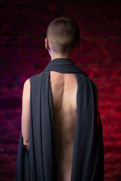Premium Photo Naked Woman With Shaved Head Wrapped In Cloth In Red Light
