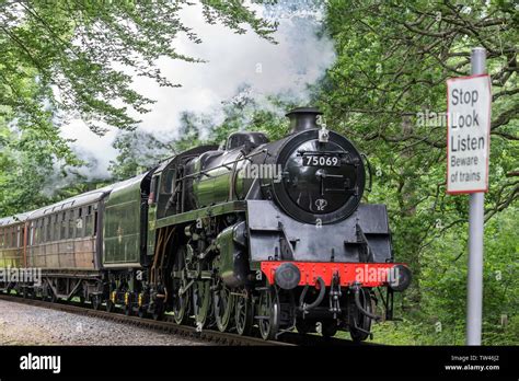 Close up of isolated vintage UK steam train front approaching, passing ...