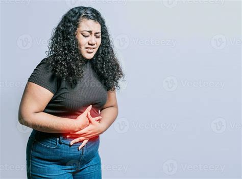 Woman with abdominal pain isolated. Young woman suffering stomach pain ...