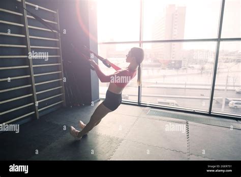 Beautiful Muscular Fit Blonde Woman Exercising Building Muscles In Gym Stock Photo Alamy
