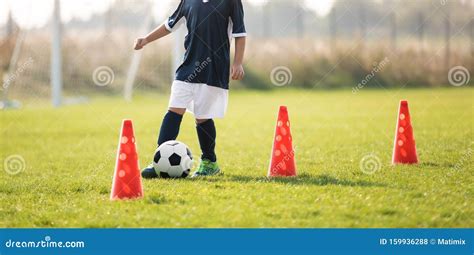 Soccer Player Dribbling Through Cones In The Ground On A Sunny Stock