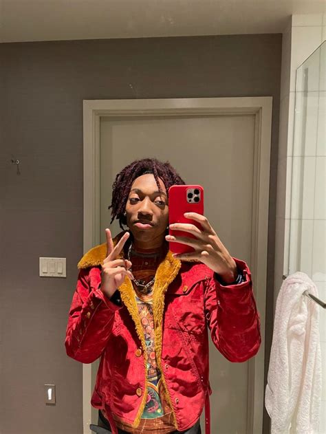 A Man Taking A Selfie In Front Of A Bathroom Mirror With His Cell Phone