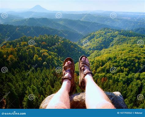 Long Tired Naked Legs In Hiking Sandals On Peak Hiking In Sandstone Rocks Hilly Landscape