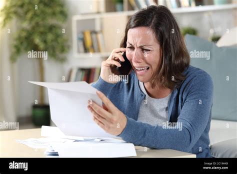 Sad Adult Woman Crying Calling On Smart Phone With Letter Sitting On