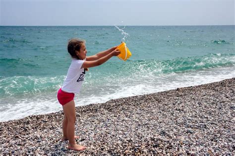 Little Girl Playing On The Beach Near Blue Sea Stock Photo Image Of