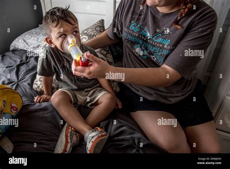 Boy Using Asthma Inhaler And Spacer Stock Photo Alamy