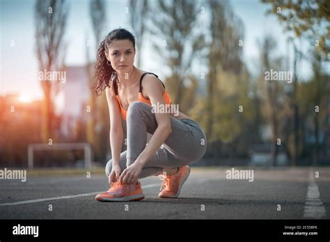 Attractive Brunette Woman Warm Up And Stretching In Park At Sunshine Stock Photo Alamy
