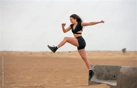Beautiful Long Hair Latin Brunette Fitness Model Wearing Black Short Fitness Outfit Exercising