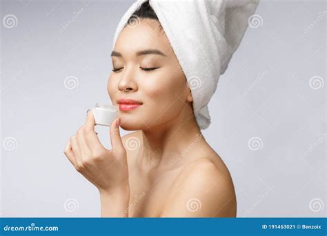 Health And Beauty Concept Attractive Asian Woman Applying Cream On