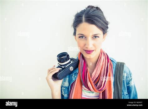 Beautiful Brunette Holding Camera Smiling On White Background Stock Photo Alamy