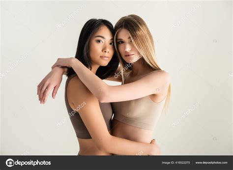 Blonde Woman Hugging Asian Model While Posing Isolated White Stock Photo VitalikRadko