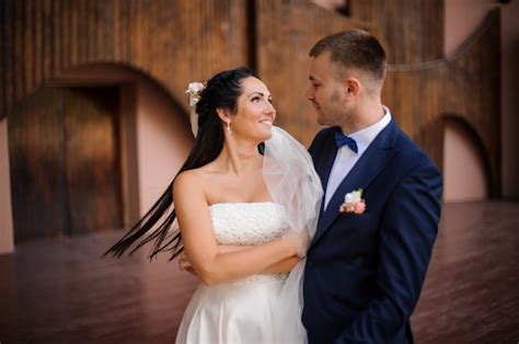 Premium Photo Beautiful Brunette Bride Looking At Her Handsome Groom