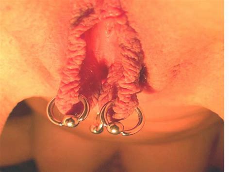 Gorgeous Wet Pink Pussy Lips Are Stretched With Multiple Piercings
