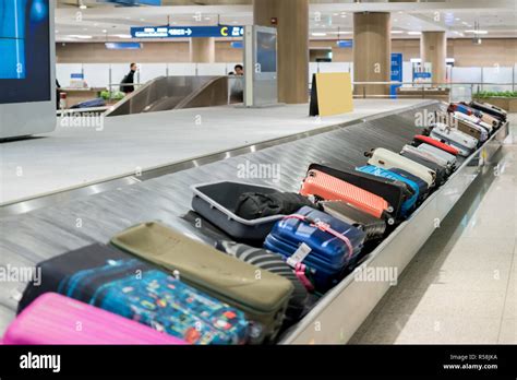 Suitcase or luggage with conveyor belt in the airport Stock Photo - Alamy