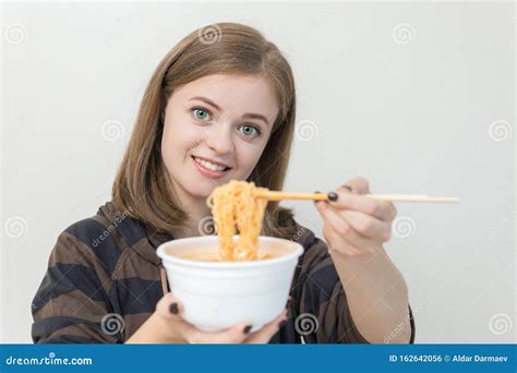 Young Caucasian Girl Woman Eating Instant Noodles Ramen With Chopsticks