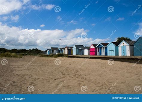 Row Of Colorful Beach Huts On A Sandy Beach On A Sunny Day Editorial