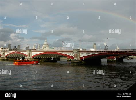 River Thames With Red Boat Passing Under Blackfriars Bridge And Rainbow