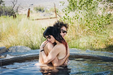 Couple Embraces In Hot Spring Tub By Stocksy Contributor MEGHAN PINSONNEAULT Stocksy