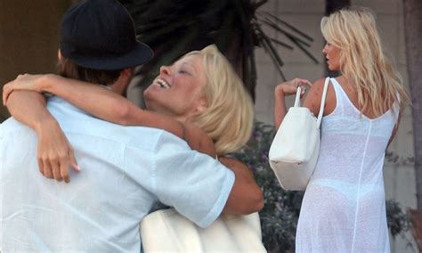 Pamela Anderson Flashes Her Derriere In Sheer Dress As She Embraces