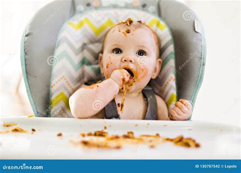 Little Baby Eating Her Dinner And Making A Mess Stock Photo Image Of