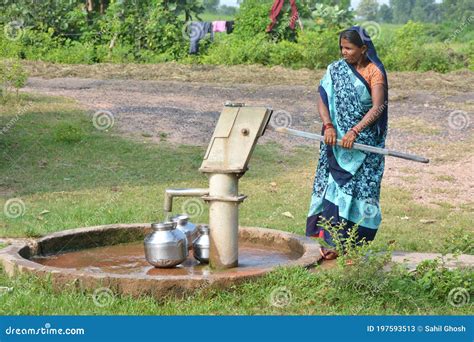 Unidentified Indian Woman Using Hand Pump For Drinking Water Editorial