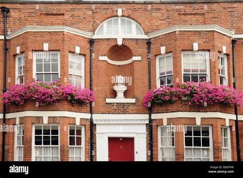 Fine Old Red Brick Built House With Bay Windows And Window Boxes Of