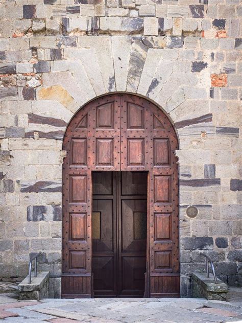 Ancient Wooden Portal With Carved Stone Arch Of An Italian Medieval