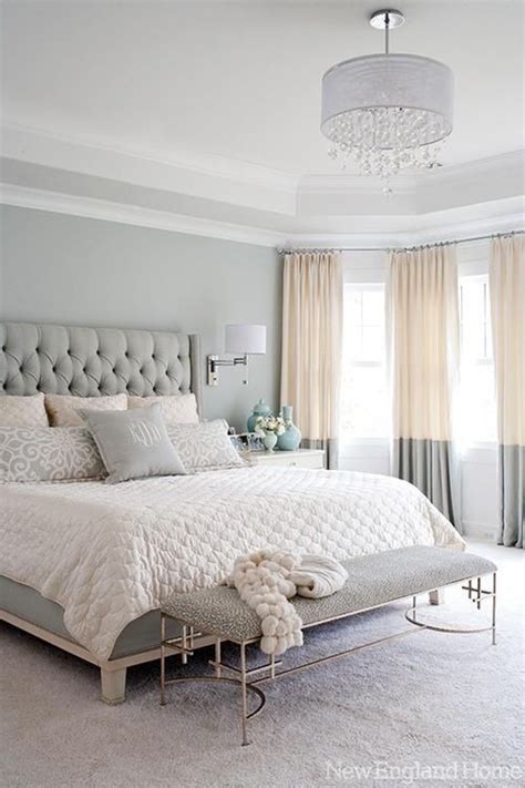 A Bedroom With Gray Walls And White Bedding In The Center Along With A