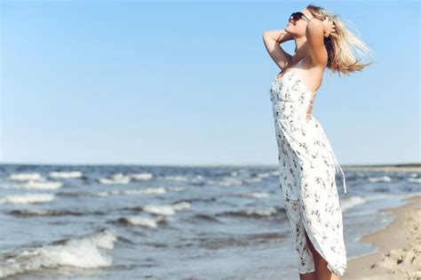 Premium Photo Happy Blonde Woman In Free Happiness Bliss On Ocean Beach Standing With Sun