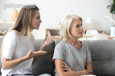 Annoyed Adult Daughter Arguing With Stubborn Old Mother Ignoring Her