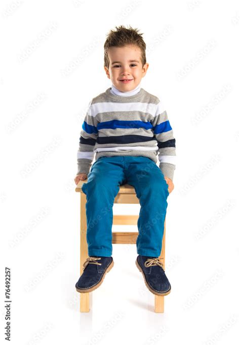 Kid sitting on chair Stock Photo | Adobe Stock