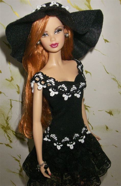 a doll wearing a black dress and hat