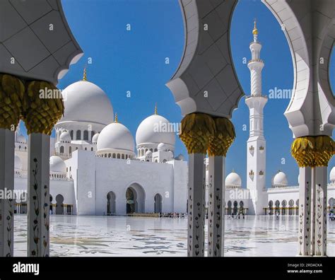 Bright White Sheikh Zayed Grand Mosque With Golden Domes Against The