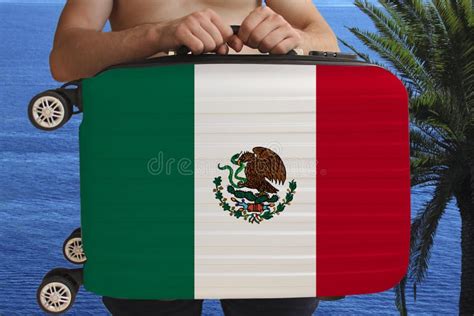 Tourist Holds With Two Hands A Suitcase With The National Flag Of