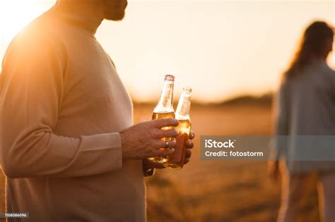 Man Holding Two Drinks Outdoors Stock Photo Download Image Now 30