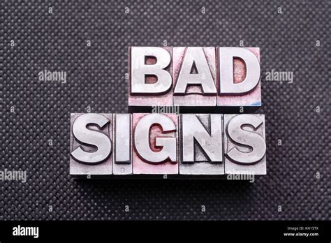 Bad Signs Phrase Made From Metallic Letterpress Blocks On Black